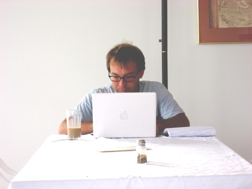 Ed writing at laptop